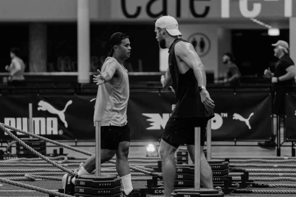 Two Men Training with Sleds in a Gym